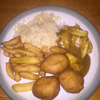 Irish Chinese chicken balls with curry sauce, chips and rice